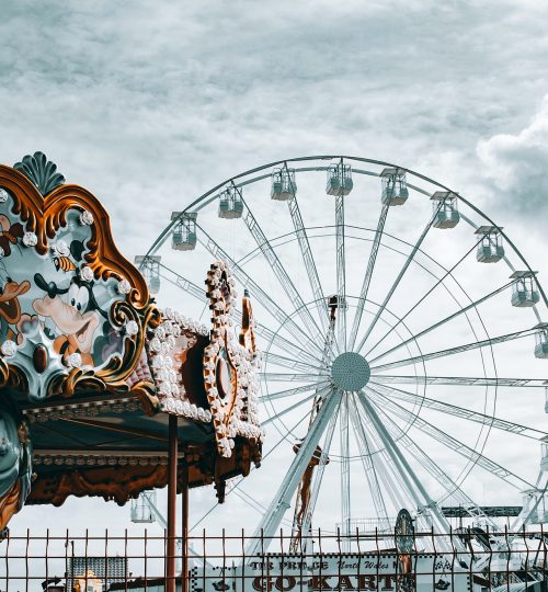 ferris-wheel-and-carousel-under-white-clouds-and-blue-sky-3967435
